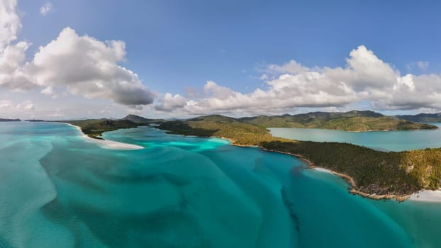 Aerial photo of the iconic Hill Inlet near Whitehaven beach on the Whitsundays, Queensland. Shot from above, gorgeous shades of aqua, blue and green mix from the silicone white sand and beach.