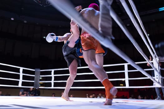 A man in a black shirt is kicking another man in the leg, fighting