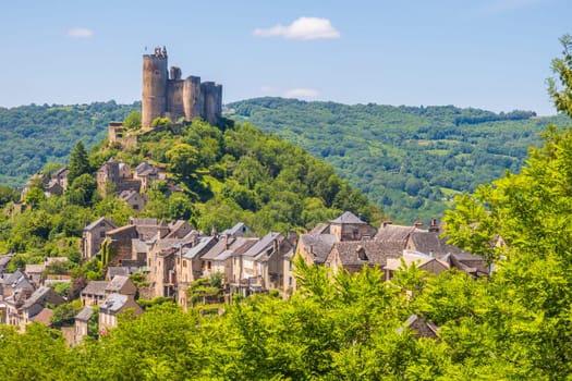 Castle of Najac towering above village houses, one of the most beautiful villages of France photographed in Occitanie region