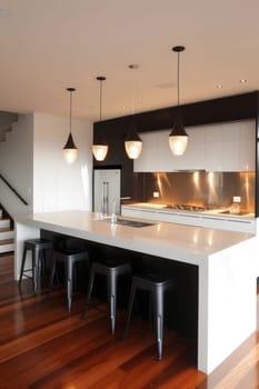 Sleek kitchen with dark tones, wood accents, and stylish black stools under a white countertop
