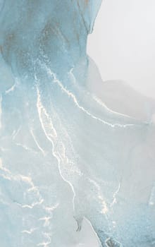 Abstract artwork featuring a blend of blue and white hues, creating a captivating swirl of color and form.