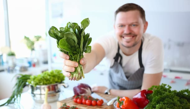 Chef Smile Showing Green Aromatic Herbal Bundle. Professional Cook Preparing Spicy Herbal Bunch and Fresh Vegetables. Spicy Plant and Ingredient for Vegetarian Food. Healthy Culinary Concept