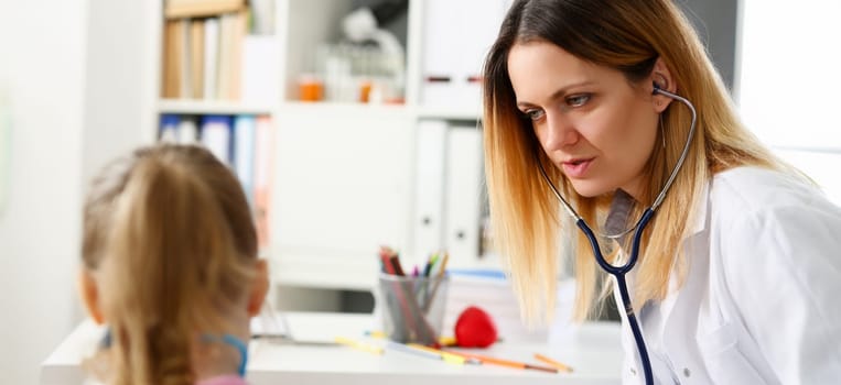 Child doctor with stethoscope communicate with little patient listening for heart beat