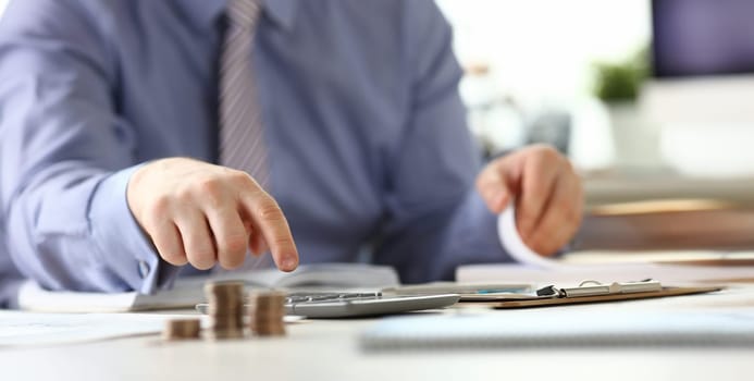 Man with Ring Calculate Revenue Tax Report Concept. Businessman Accounting Financial Business Data Using Calculator, Stationery at Workplace. Office Worker do Bureaucracy Paperwork