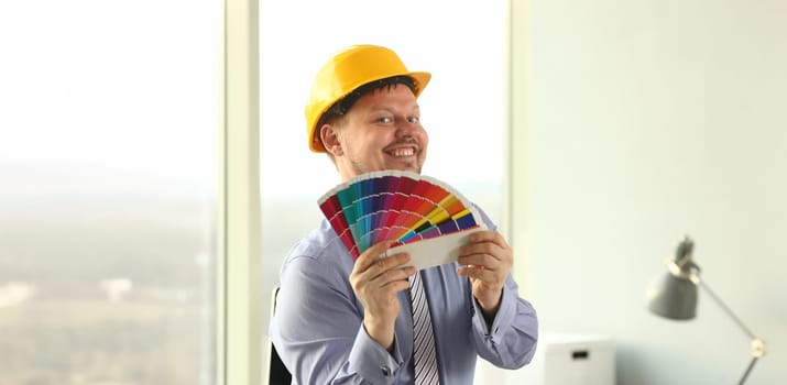 Graphic Designer Holt Architectural Color Palette. Engineering Creative Office. Colour Swatches, Samples for Selection. Interior Decoration and Technology Concept. Man in Yellow Hard Hat