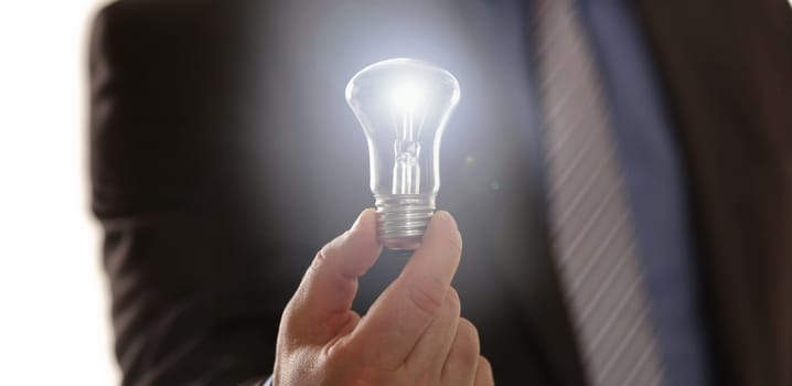 Inspiration Symbol Saving Electric Energy Idea. Man Entrepreneur Holding Traditional Light Bulb. Formal Suit Businessman with Lamp in Hand. Innovation Technology New Business Vision