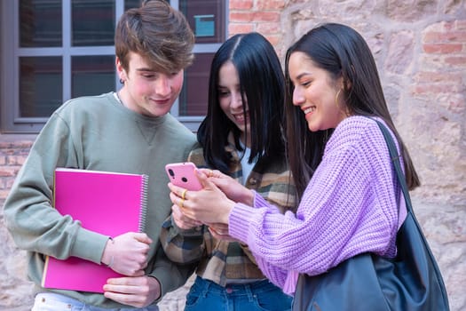 Three Multiethnic Friends Having Fun Using Social Media With Their Cell Device College Life Concept