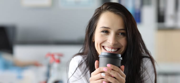 Smiling woman hold black paper moog with coffee drink portriat. Morning energy concept
