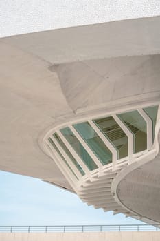 Detailed view of a building facade showcasing innovative architectural design with large windows and geometric patterns. The structure highlights modern urban architecture.