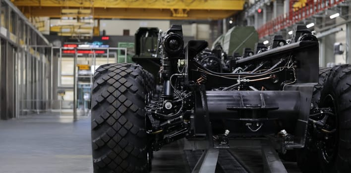 Close-up of coupling joint washers on cross of automobile cardan shaft. Mechanical parts of auto steering system repaired in modern workroom. Car repairing workshop concept