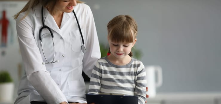 Female doctor exam child patient in hospital office portrait. Medical baby treatment concept
