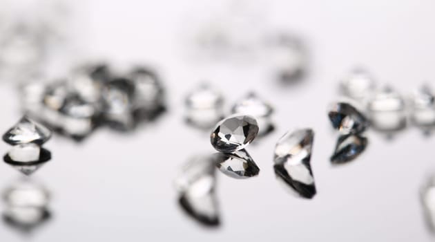 Scattering of white star diamonds on black background table jeweler concept