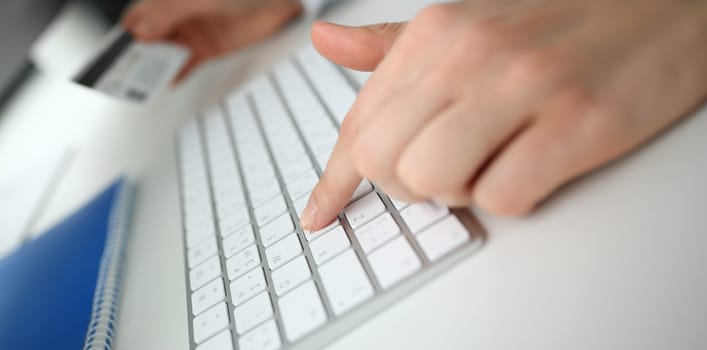 Female arms hold credit card press buttons making transfer closeup. Anti-fraud financial security when entering client discount program number or filling personal credential password login to account