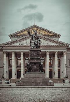 Munich, Germany - Dec 21, 2023 - Monument Bronze Statue of King Maximilian I Joseph of Bavaria in front of The National Theatre of Munich (Nationaltheater) or Bavarian State Opera (Residenztheater) at the Max Joseph Square in central Munich. Space for text, Selective focus.