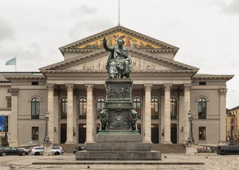 Munich, Germany - Dec 21, 2023 - Monument Bronze Statue of King Maximilian I Joseph of Bavaria in front of The National Theatre of Munich (Nationaltheater) or Bavarian State Opera (Residenztheater) at the Max Joseph Square in central Munich. Copy space, Selective focus.