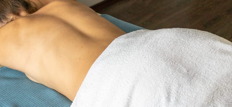 Shot of the young female relaxing after massage in the spa