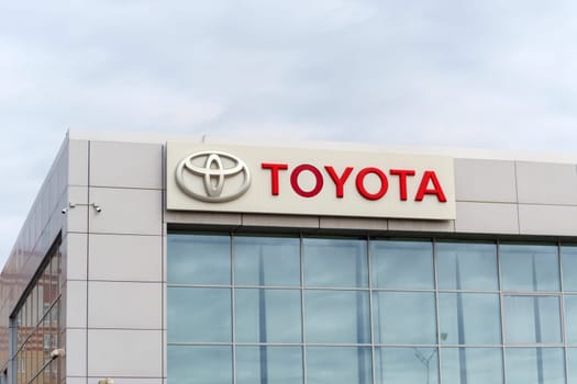 Tyumen, Russia-March 02, 2024: Toyota brand logo sign prominently displayed on the side of a commercial building in a city.