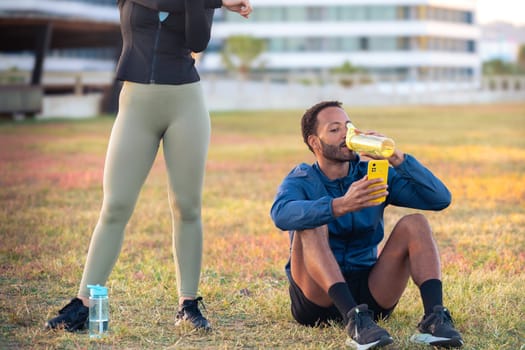 Youngs athletes using apps on their phone to track their exercise routine while training