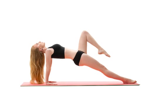 Slim long haired blonde in black top and pants doing handstand studio shot