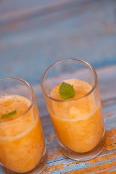 Bowl of tasty melon sorbet, melon and mint leaf verrine, High quality photo