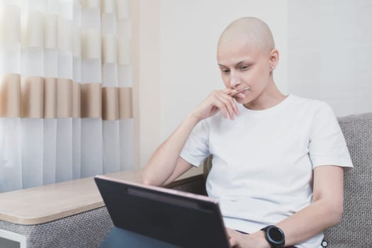 Woman with oncology after chemotherapy working remotely at home.