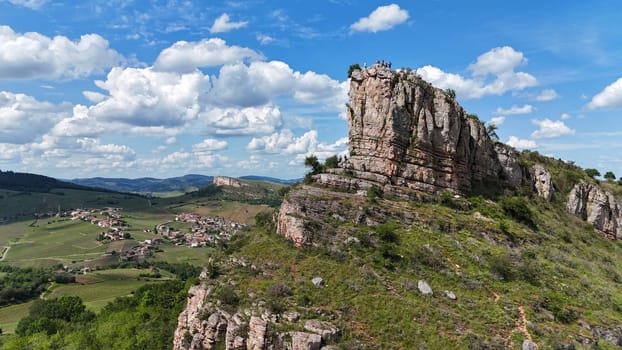 Saone et Loire,France,25-05-2024: , Solutre Pouilly, people and mountain climbers climb the rock of Solutre and vineyard fall