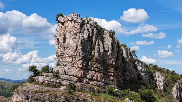Saone et Loire,France,25-05-2024: , Solutre Pouilly, people and mountain climbers climb the rock of Solutre and vineyard fall