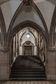 Munich, Germany - Dec 21, 2023 - Gothic architectural style with arches of famous New Town Hall (Neues Rathaus) on Marienplatz square in Munich. Beautiful Corridor with Staircase, Ceiling, Pillars and Lamp, Space for text, Selective focus.