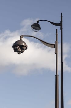 France, Paris - Jan 05, 2024 - Pole Street Lights (Lamp post) and CCTV Surveillance Camera Pole against a Cloudy sky in Paris on a Sunny day. Space for text, Selective focus.