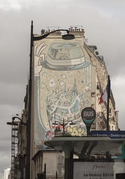 France, Paris - Jan 03, 2024 - The place of Vous Etes Ici Mural on Rue La Fayette, canal de l'Ourq. Street art on wall decor old building in Paris, Urban intervention art, Paris street artwork, Paris wall art, Space for text, selective focus.