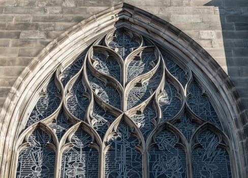 Edinburgh, Scotland - Jan 18, 2024 - Exterior detail of Large arched window of St Giles' Cathedral or the High Kirk of Edinburgh in gothic style. Space for text, Selective focus.