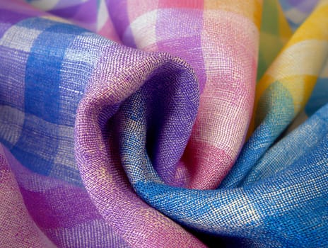 Colorful woven plaid fabric with intricate and vibrant texture, perfect for crafting and design projects