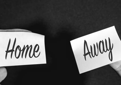 Two sticky notes on a black background, with Home and Away on it.