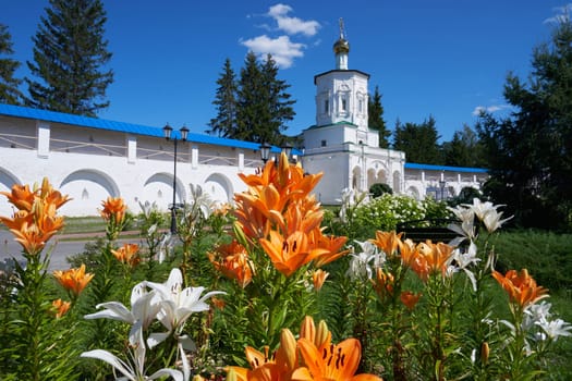 Ornamental garden with lilies in the courtyard of an ancient monastery