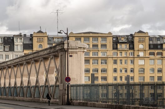 France, Paris - Jan 05, 2024 - People walking along a Bridge on Rue La Fayette. Bridge built above the railways of gare de l'Est, Pont de Lafayette, Rue de l'Aqueduc, Copy space, Selective focus.