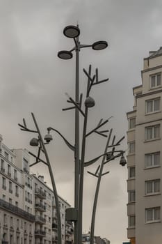France, Paris - Jan 05, 2024 - "Tree of light" Inspiration from trees in nature. Pole Street Lights (Lamp post) and CCTV Surveillance Camera Pole, Street Light Design in the city of paris, Space for text, Selective focus.