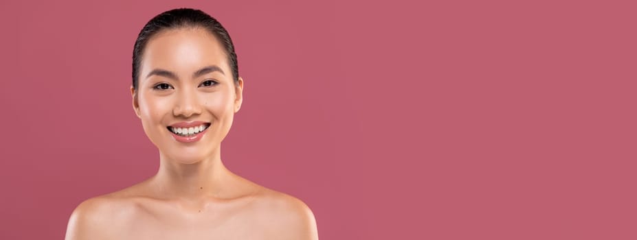 Portrait of attractive naked young japanese lady posing on purple studio background, cheerfully smiling at camera, copy space. Skin and body care for young women, healthy lifestyle concept