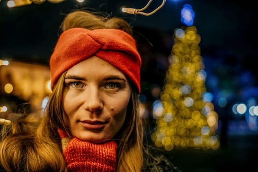 Winter fun on the street: Girl with sparklers, smiles in warm jacket and hat. Festive Christmas or New Year celebration,