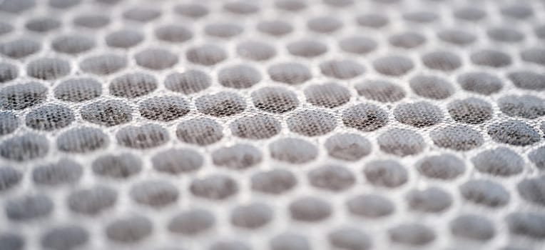 Close-up of multi-stage air filter with uv radiation and activated carbon granules. Replaceable carbon air purifier filter. Hepa filter surface background