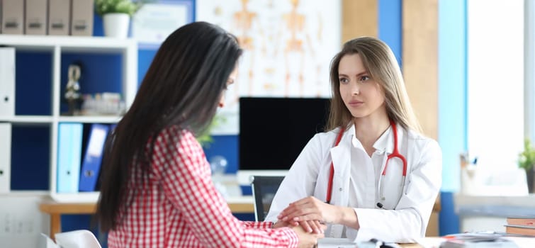 Portrait of female patient at doctor appointment, incurable disease. Doctor calming down upset woman. Healthcare and medicine concept