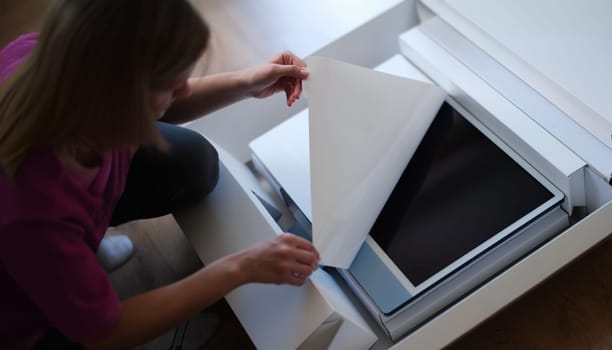 Close-up of woman hands unpacking box with modern personal computer. Latest technological innovations, digital equipment and electronics