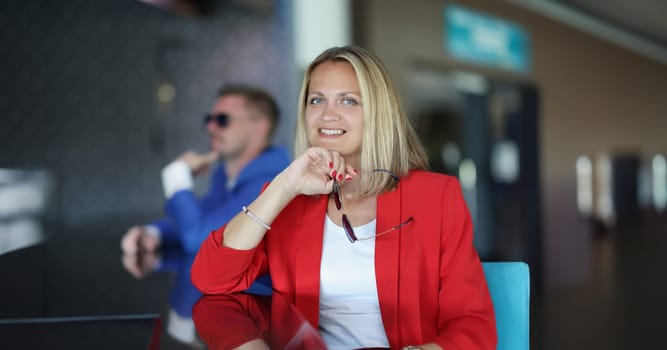 Portrait of happy smiling businesswoman posing in business clothes. Cheerful woman looking at camera with happiness. Business trip concept