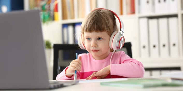 Portrait of little girl wearing headset, fun pastime or online education. Childhood, development or preschool class concept