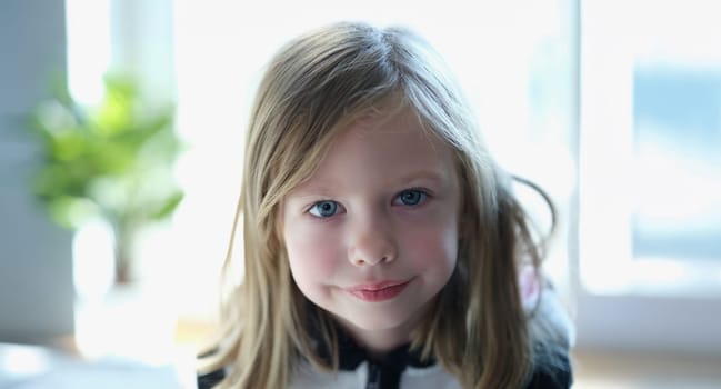 Portrait of little smiling child posing and looking at camera with happiness. Cheerful girl kid. Happy childhood concept