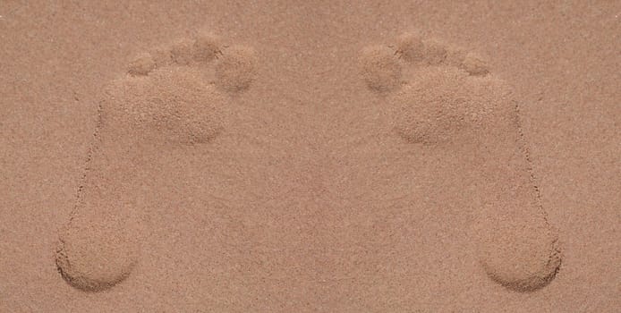 Top view of footprints in sand at beach, lonely trace on sandy surface on coast. Summer sea vacation and leisure at sea concept