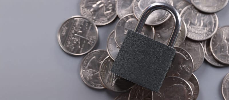 Close-up of padlock on coins, financial security and protection finance. Keep savings in secure place. Keep money savings in secure place