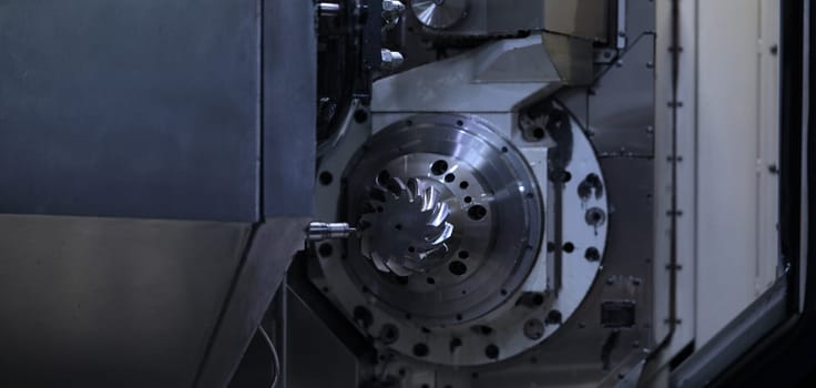 Close-up of metalworking cnc milling machine, cutting metal modern processing technology. Turning with cutting and milling tool outer surface detail of metalworking parts