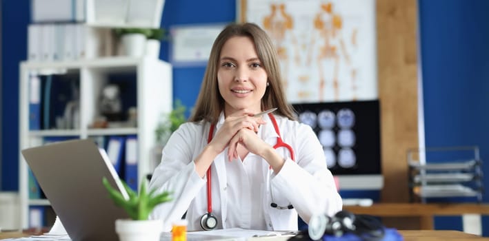 Portrait of smiling female doctor in gown, young medical specialist working in clinic. Healthcare, medicine, emergence and save life concept