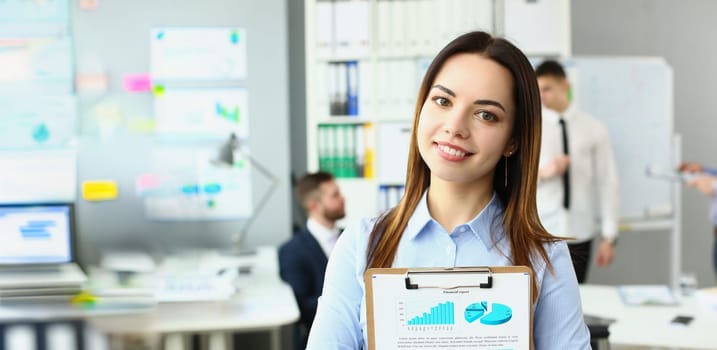 Portrait of smiling businesswoman stand with clipboard, manager analysing statistics date. Business, teamwork, developing new project or startup concept