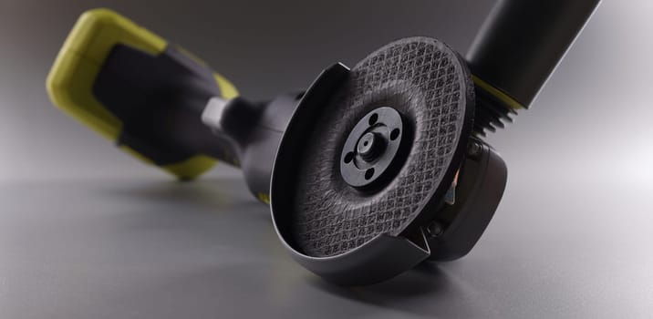Close-up of powerful circular saw equipment for construction works. Electrical saw, grinder for metal works on grey background. Carpentry concept